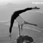 A wife and children yoga on a cliff rock.