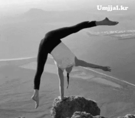 A wife and children yoga on a cliff rock.