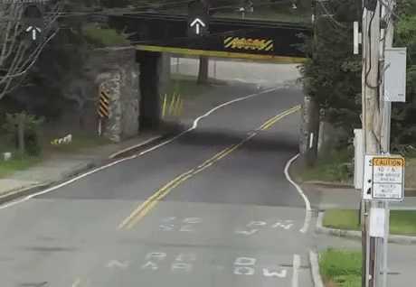 A truck that narrowly passes under the bridge.gif