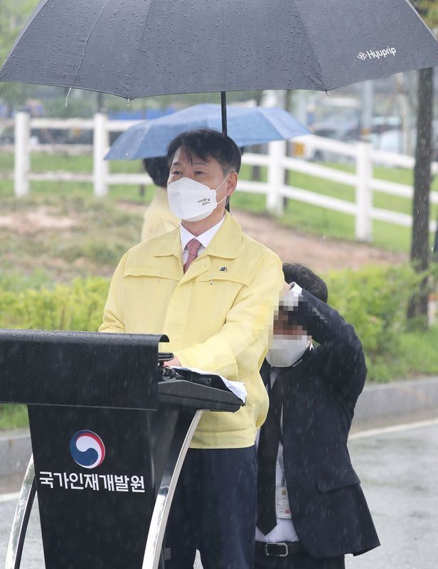 I'm briefing the deputy justice minister, and he's offering his umbrella on his knees.