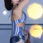 Hyeming dance reaction in a swimsuit-like outfit.