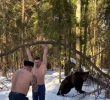 SOUND. A video of a bear working out on a snowy snowy mountain with a human sandbag.
