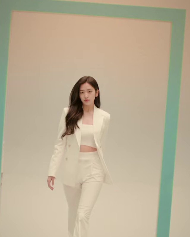 YU JIN wearing a cropped outfit and a jacket.