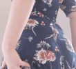 A girl in a flower dress who shows her butt