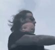 A father riding a bike with a baby