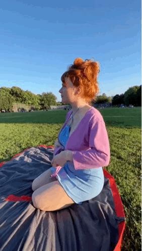 A girl who shows side boop at a picnic