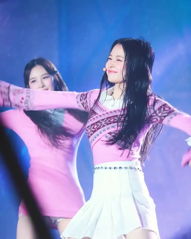 Weekly JIHAN performing in the rain wearing a white skirt