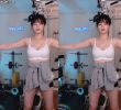 Cho-dan zips down and shows a white tank top breast