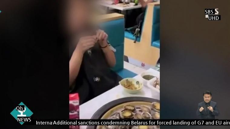 Chinese Woman Picks Abalone From Seafood Buffet