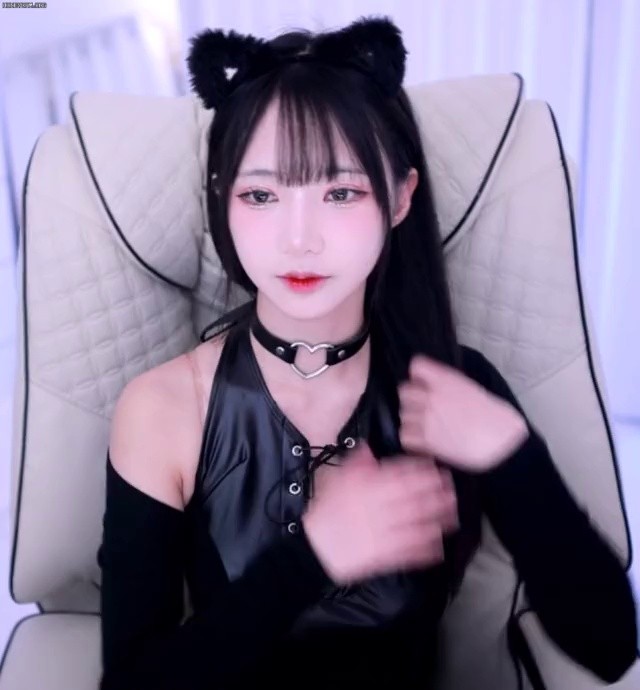 A girl group-like visual cat woman with a hole in her chest