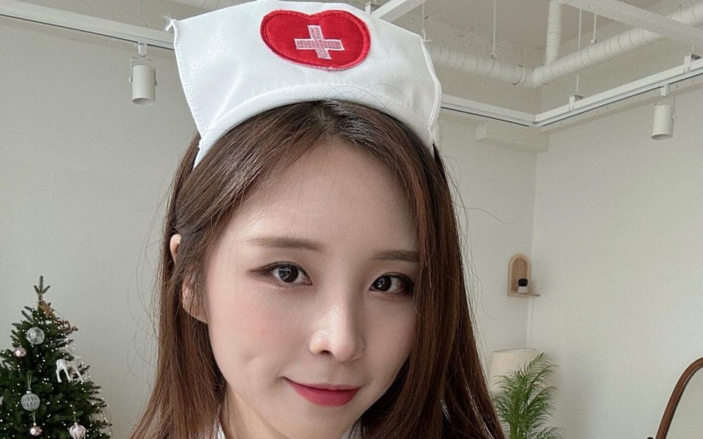 Flower buns in racy nurse's uniform