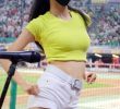 Lee So-young cheerleader, baggy yellow cropped T-shirt, white shorts.