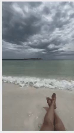 Sharks approaching a woman sunbathing on the beach in a flash