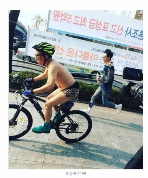 There's a crazy guy riding a bike in his underwear