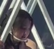 TWICE Nayeon is crossing her legs while sitting on a structure