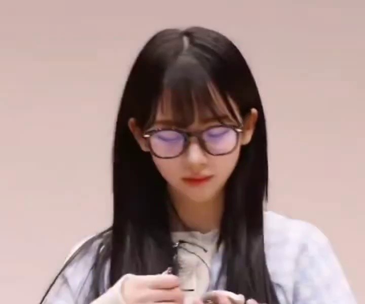 Karina, who put glasses on a menggu doll and likes that it's the same