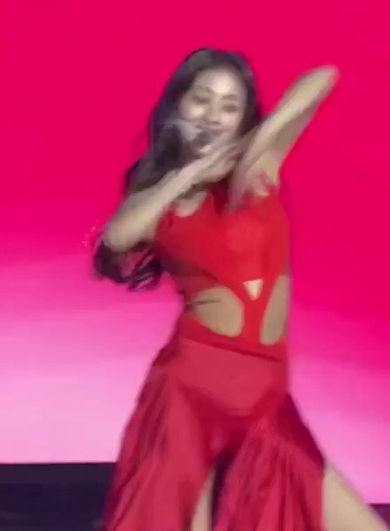 JIHYO from TWICE, who is wearing a strong red halter neck outfit
