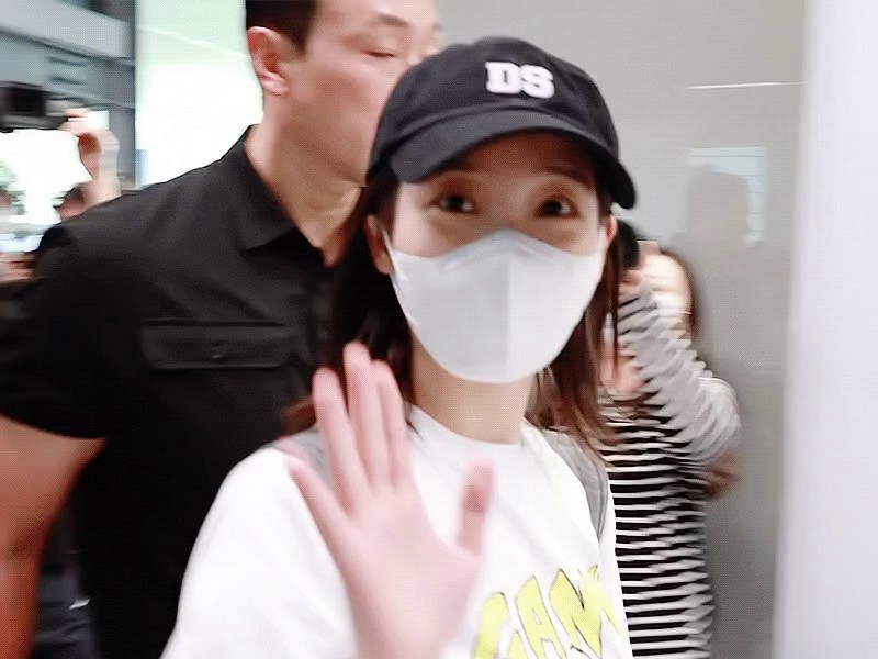 IU at the airport wearing a rabbit suit
