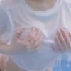 Eddie Rin coming out of the water holding a wet white t-shirt and no bra.
