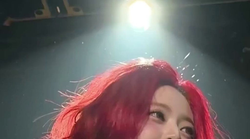 ITZY's red hair taken from below Yuna's white crop top, narrow waist and belly button