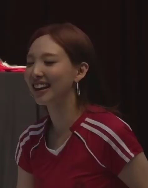 Nayeon jumping around in a red soccer uniform - Fansign